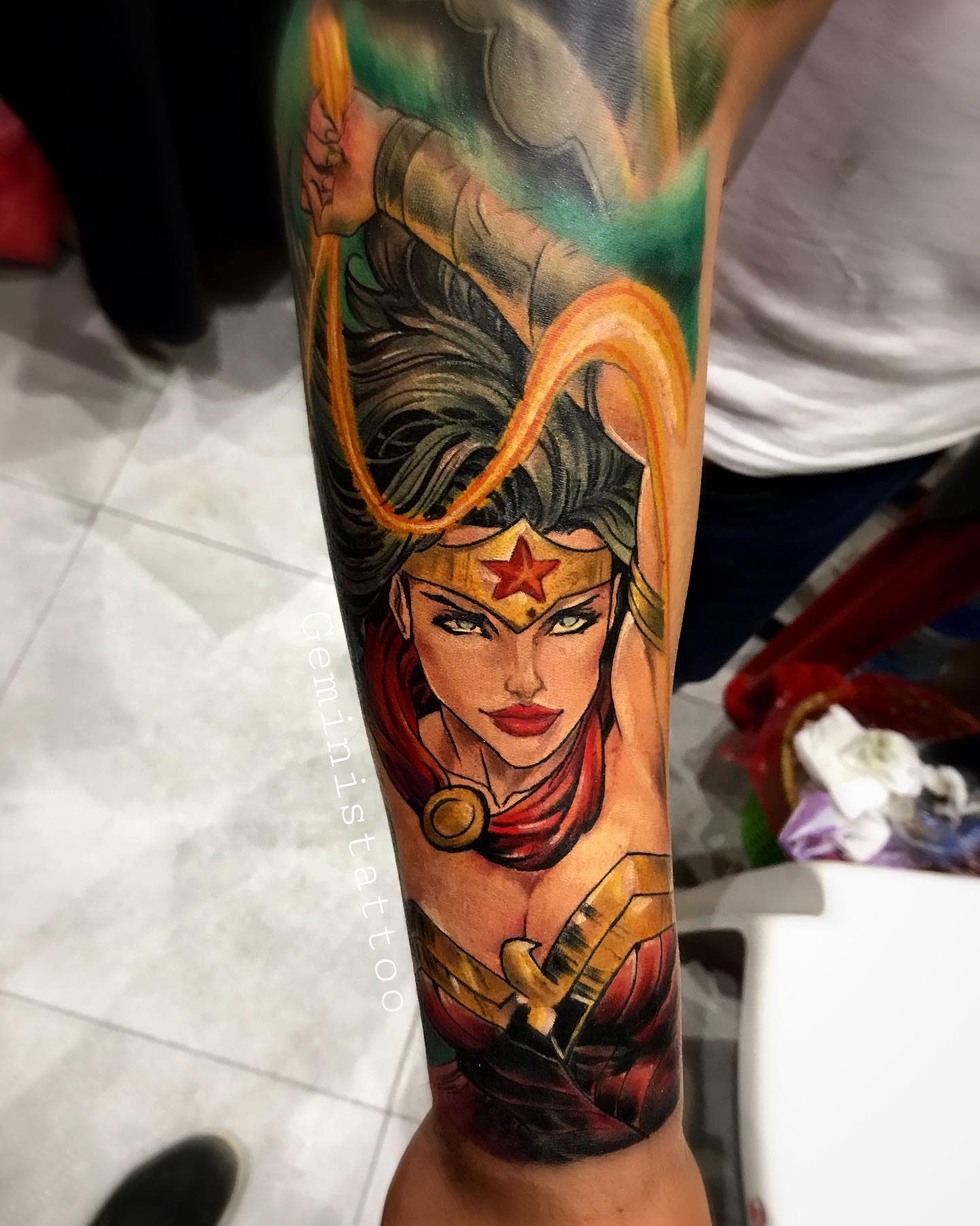 Tattoo features Wonder Woman in a powerful and dynamic pose, wielding her Lasso of Truth