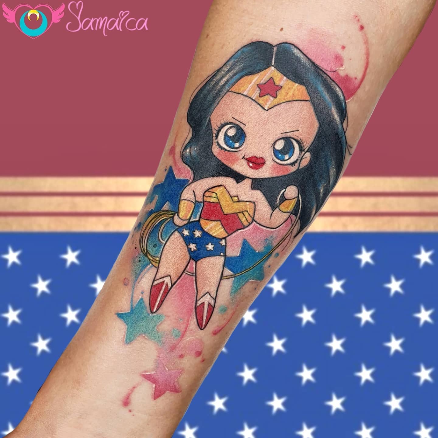 Chibi-style Wonder Woman tattoo with bright watercolor accents, featuring big eyes and cute details