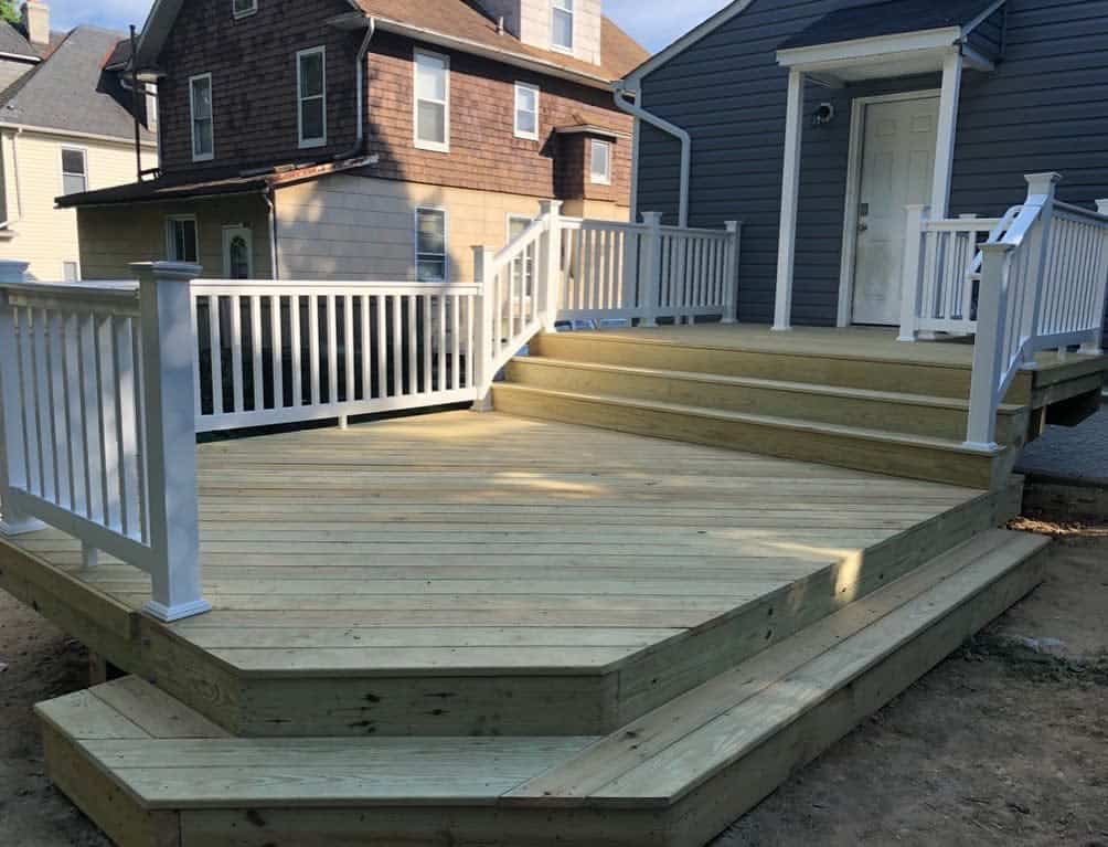 large empty backyard wood deck white railing