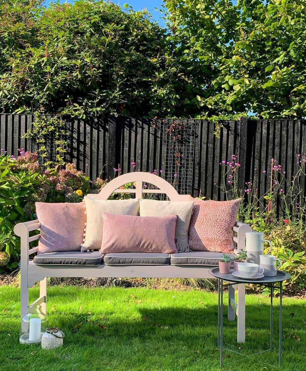 pink wood backyard bench small table with tea set pink pillows