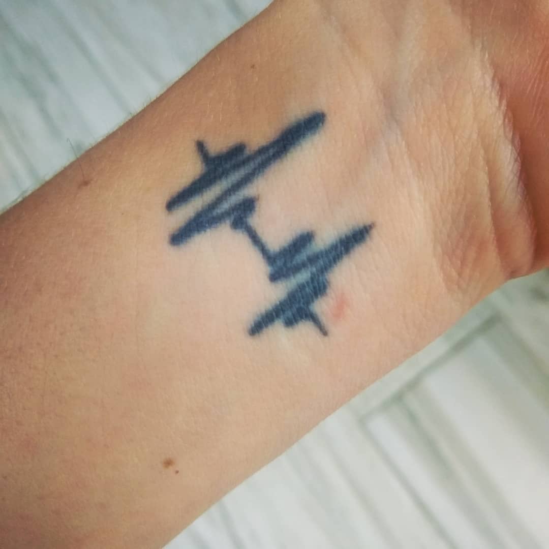 A tattoo of two EGC heartbeats on a wrist