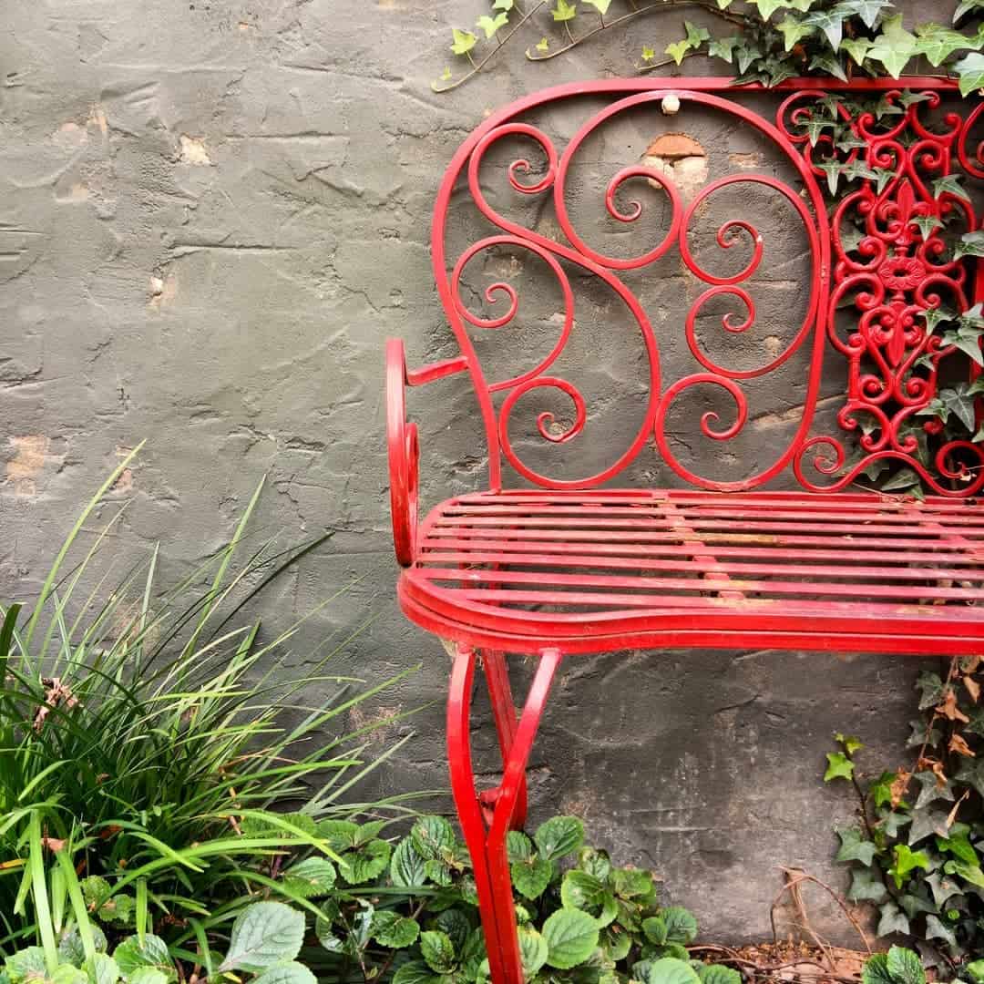 red wrought iron garden bench