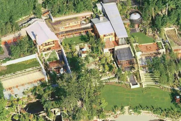 Xanadu 2.0 estate in Seattle with modern architecture, green roofs, and wooded surroundings.