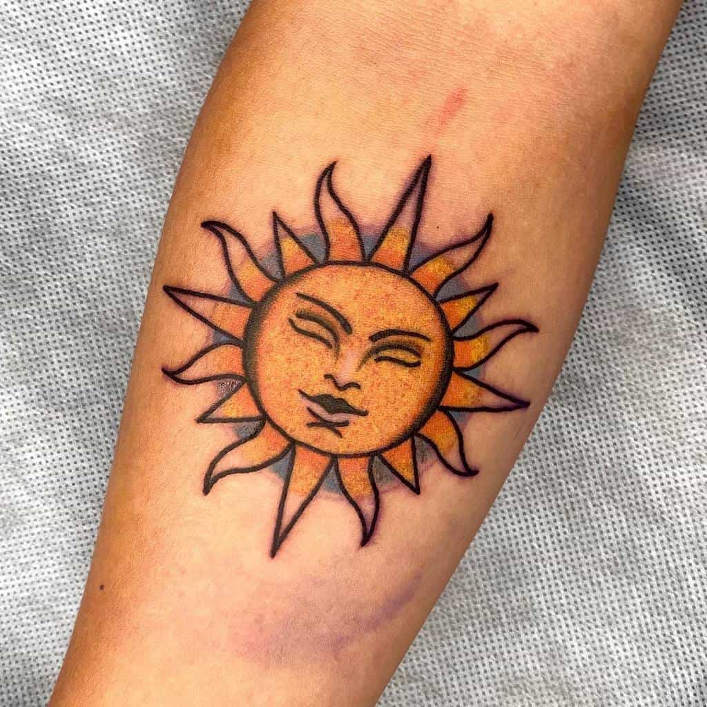 Tattoo of a yellow sun with a face on an arm
