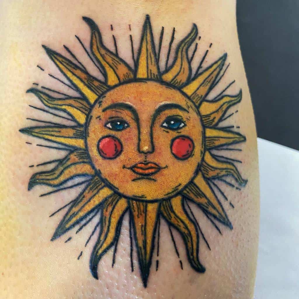 Tattoo of a stylized yellow sun with a face and wavy rays