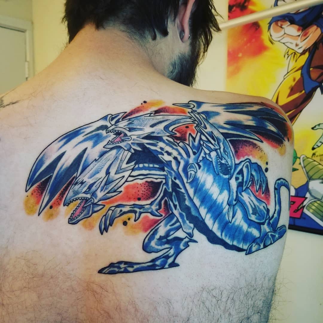 lIndividual with a large blue dragon tattoo on the back