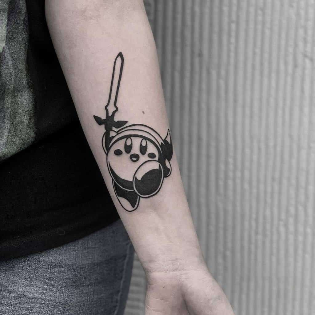 Bold black ink tattoo of Kirby as Link from The Legend of Zelda, wielding a sword and wearing a hero’s cap