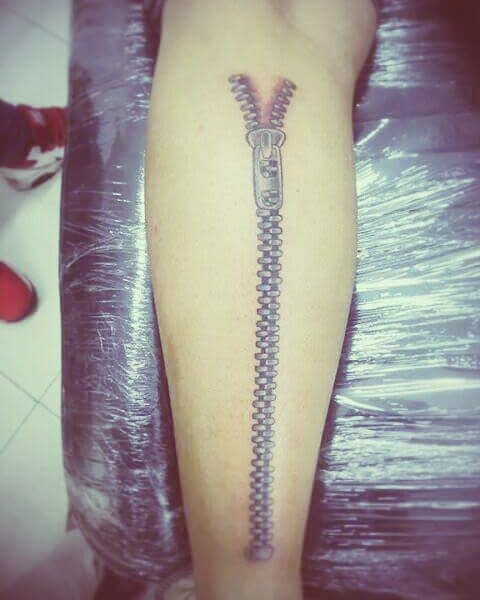 Realistic zipper tattoo on the back of a calf