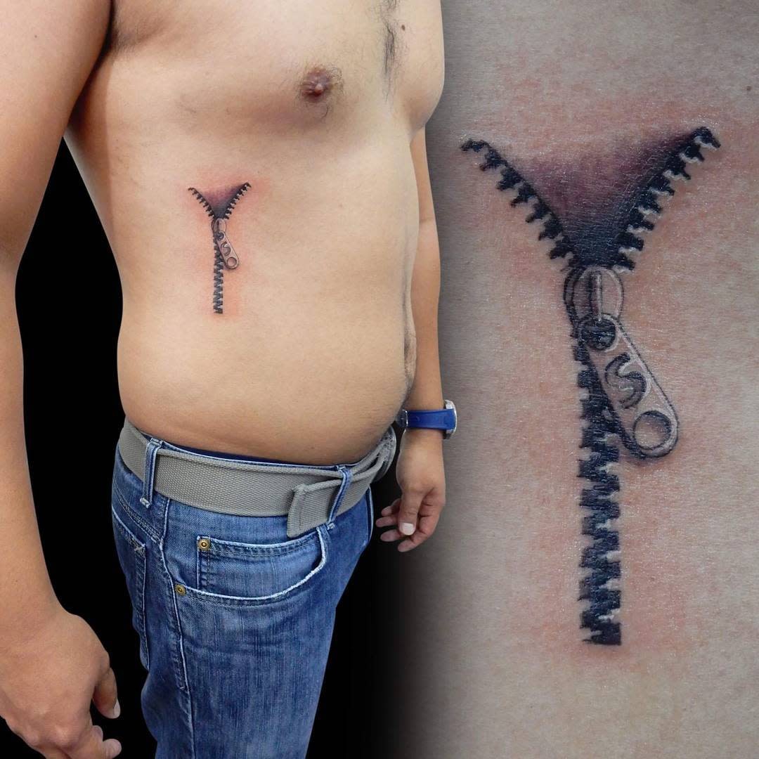 Tattoo of a zipper on their right side, extending from ribs to abdomen