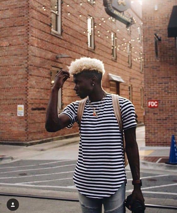 An afro Mohawk hairstyle with platinum blonde hair