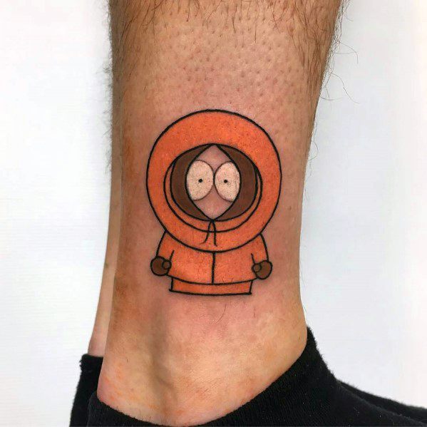 Minimalist Kenny tattoo from South Park on the ankle, featuring bold black outlines and an orange hoodie for a classic look.