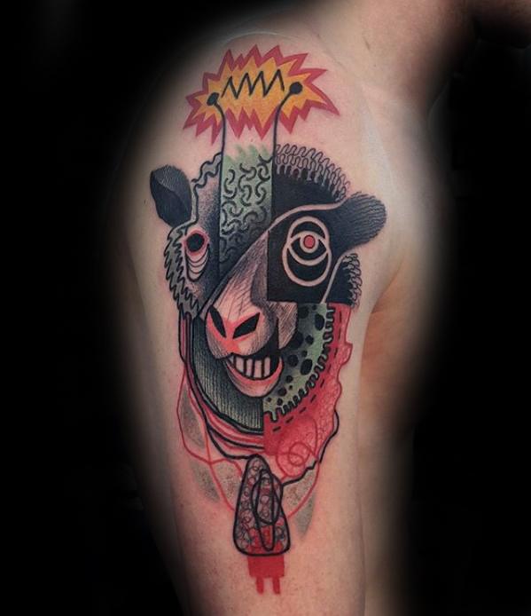 Abstract tattoo of a stylized sheep, featuring geometric patterns and vibrant colors on an upper arm