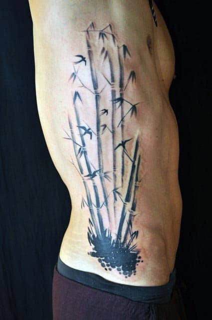 Abstract Bamboo With Flying Bird Leaves Mens Ribs Tattoo