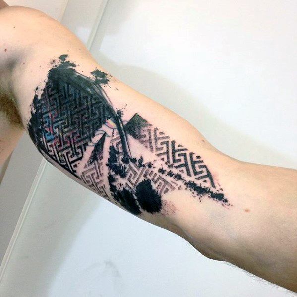 Blast over geometric tattoo with black ink patterns on a person's upper arm