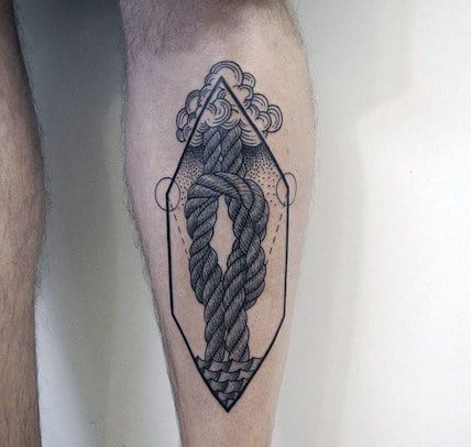 Tattoo of a rope knot inside a diamond shape with clouds on a person's leg