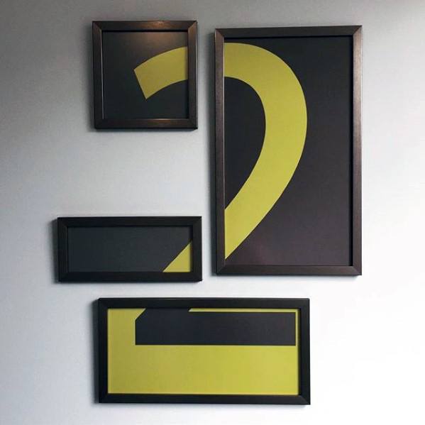 Four framed abstract art pieces on a wall, forming the shape of a question mark
