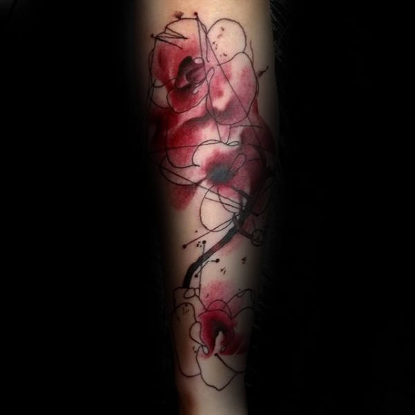 Abstract orchad watercolor tattoo on forearm with red and black ink, featuring artistic swirls and splatters