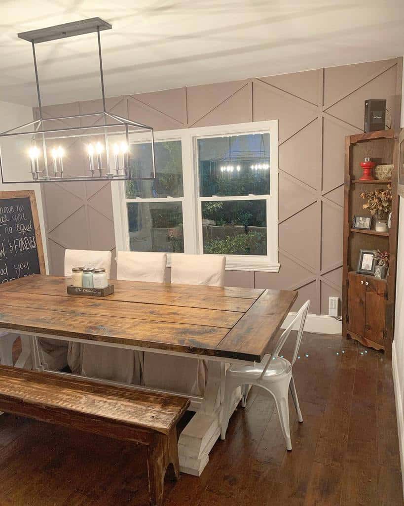 pink textured accent wall long wood table white chairs corner cabinet chandelier track lighting 