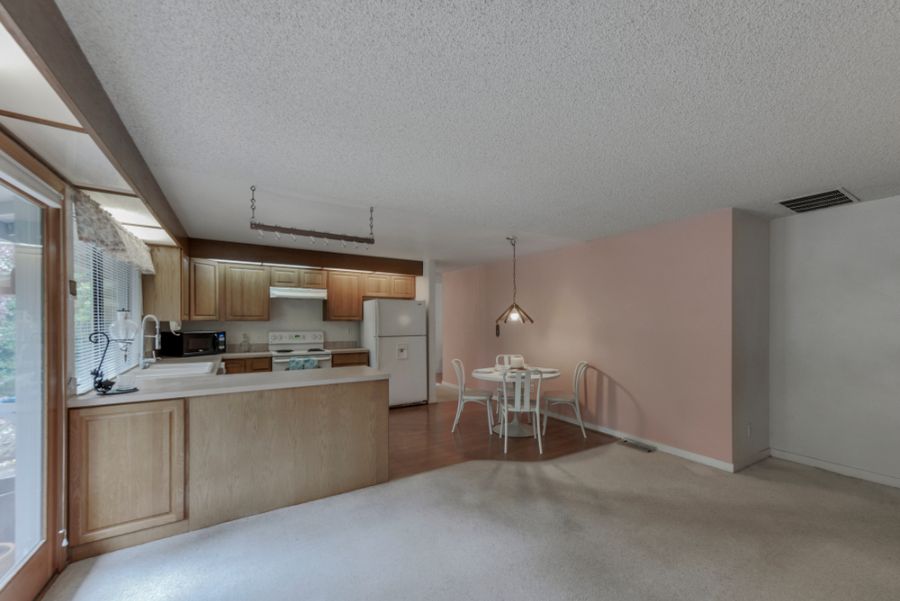 pink accent wall open plan kitchen dining room