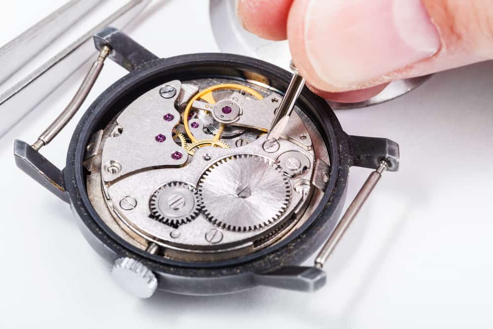 close up of adjusting old mechanic wristwatch
