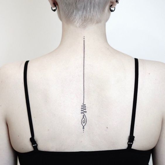 Minimalist Unalome tattoo along the spine, symbolizing the journey to enlightenment, spiritual growth, and inner balance.