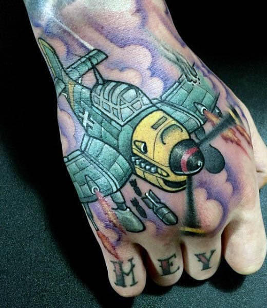 Tattoo of a cartoon-style airplane on a hand with "HEY" inked on the fingers