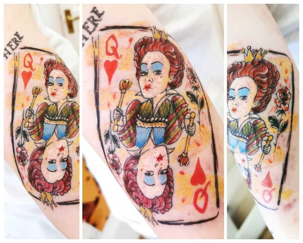 Tattoo of a Queen of Hearts card with vibrant colors on an arm