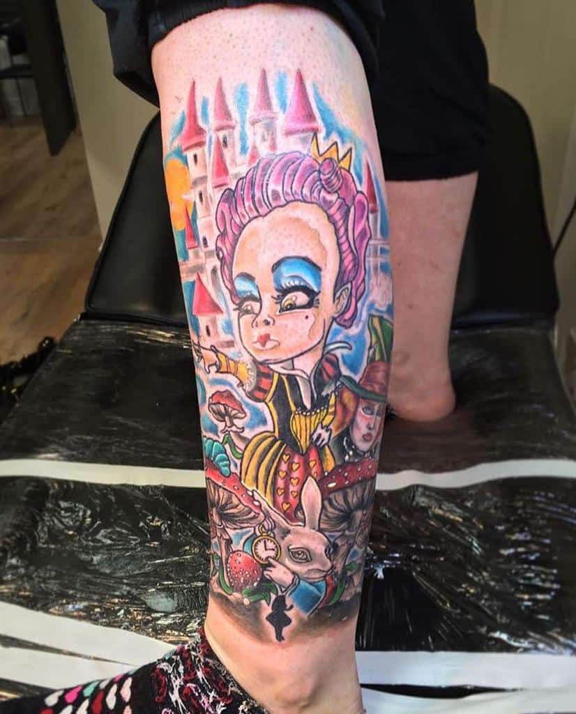 Colorful Queen of Hearts tattoo featuring a whimsical castle, White Rabbit, and vibrant Alice in Wonderland details
