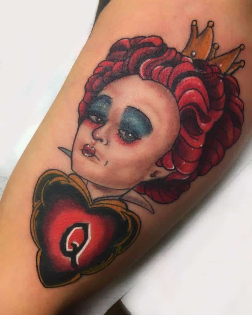 Bold Queen of Hearts tattoo design with striking red and black tones, accented by her golden crown and heart motif