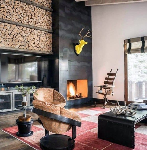 Cozy living room with a fireplace, eclectic seating, and stacked firewood wall decor.
