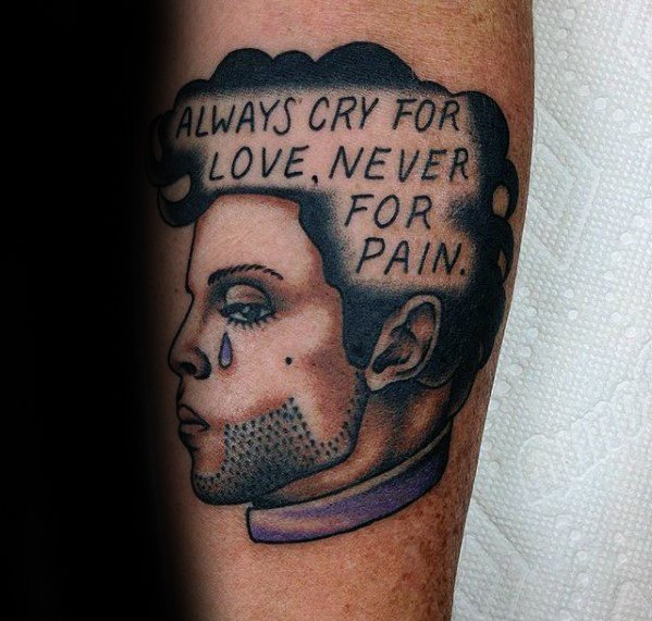 Prince tattoo with his portrait, a teardrop, and the quote "Always cry for love, never for pain"