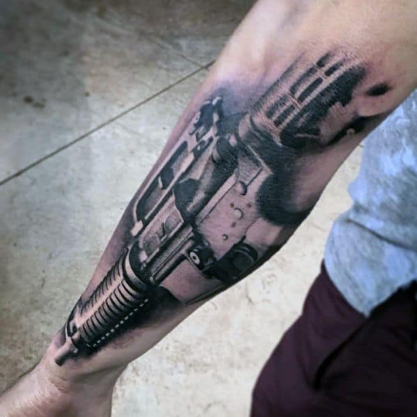 Realistic black and grey AR-15 tattoo on the forearm, featuring intricate shading and depth, symbolizing strength, precision, and tactical readiness.