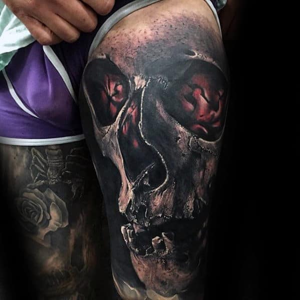 Amazing 3d Skull With Glowing Red Design Tattoo For Men On Thigh