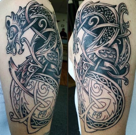 Celtic-style dragon tattoo with intricate interwoven patterns on an upper arm