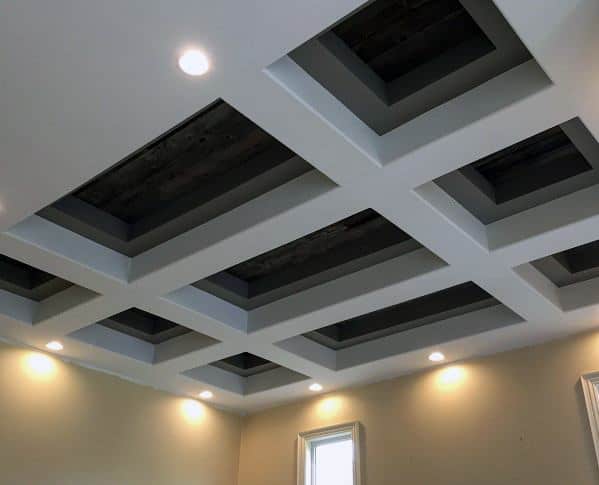 Modern coffered ceiling design with recessed lights and dark wood insets.