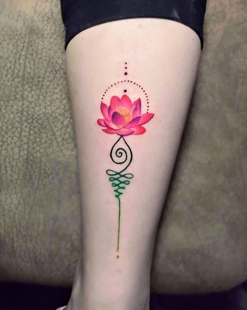 Unalome tattoo with a vibrant pink lotus on the leg, symbolizing spiritual enlightenment, growth, and the journey to inner peace.