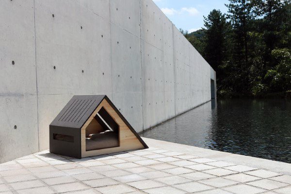 Sleek modern dog house with an angular roof and wooden side panels