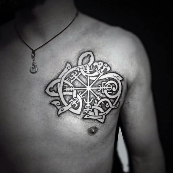 Black and grey dotwork Viking compass (Vegvísir) chest tattoo with intricate knotwork on a shirtless man’s upper chest.