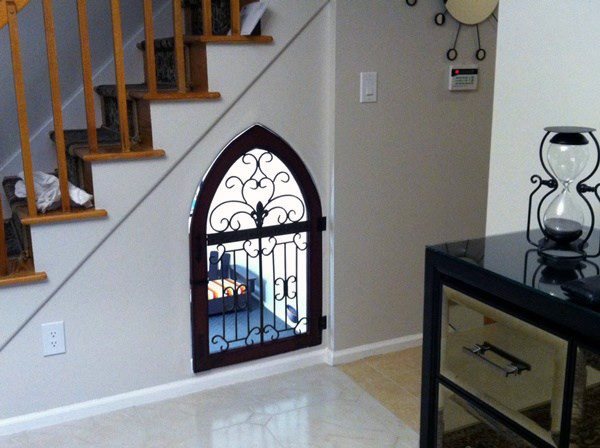 under the stairs dog house with black gate
