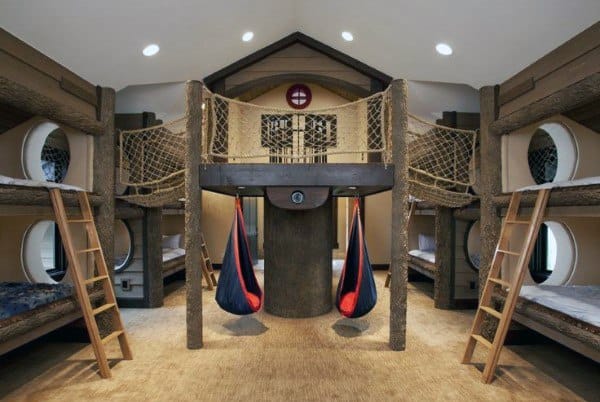 Playful kids' bunk bedroom with ladders, suspended hammocks, and a rope bridge