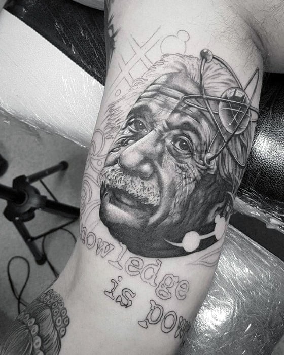 Black and gray tattoo of Einstein with "knowledge is power" text on forearm