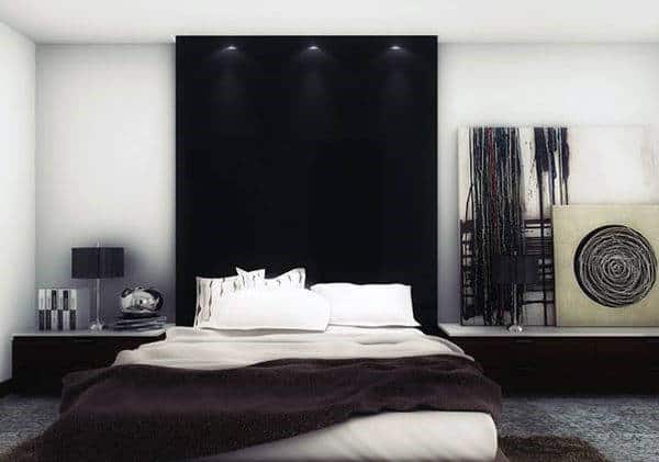Modern bedroom with black accent wall, abstract art, and minimalistic decor