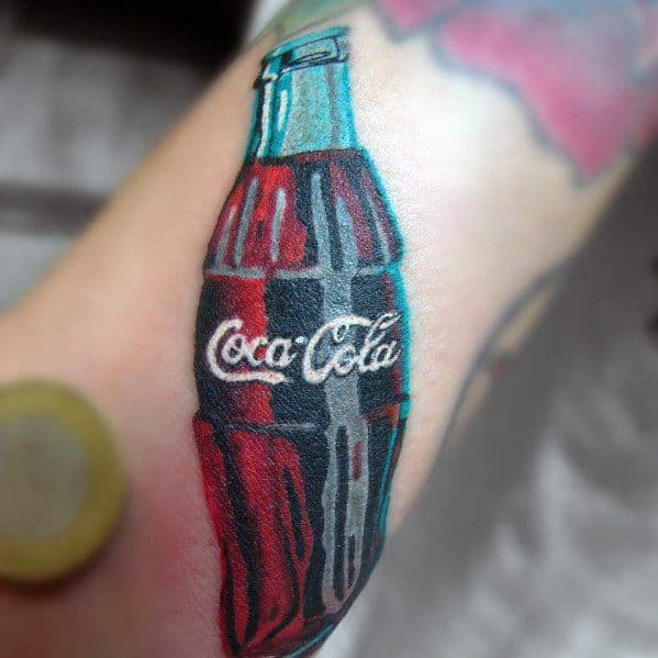 Realistic Coca-Cola bottle tattoo with a bold 3D effect, featuring vibrant red and black tones with the classic logo on the arm.