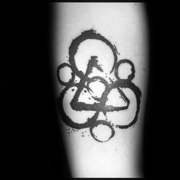 Abstract Keywork tattoo with bold black brushstroke circles and triangle, inspired by Coheed and Cambria’s iconic band logo.