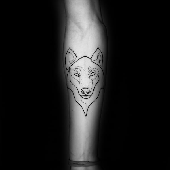 Wolf continuous line tattoo on forearm with a minimalistic design, featuring bold black lines forming a geometric wolf face.
