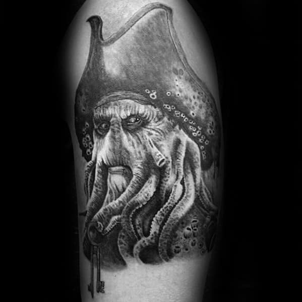 Tattoo of Davy Jones with an octopus-like face and hat on an arm