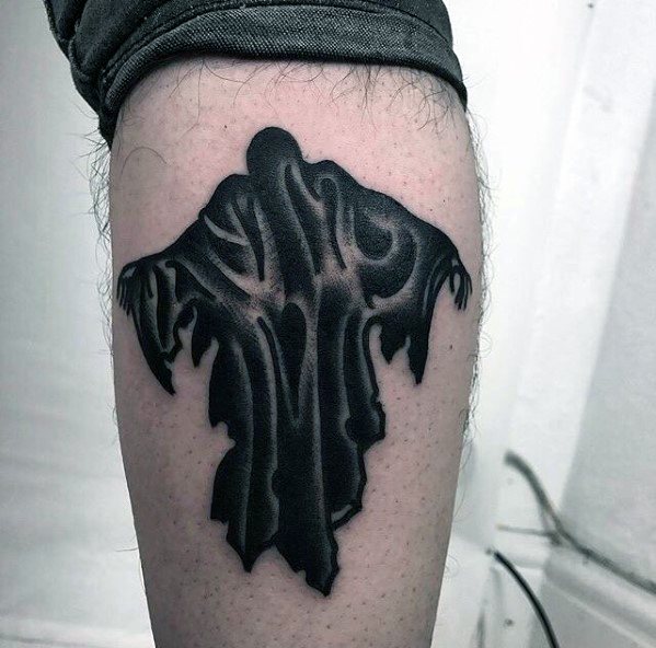 Dementor tattoo design on upper arm, featuring a dark, shadowy cloaked figure with eerie, flowing, ghost-like details.