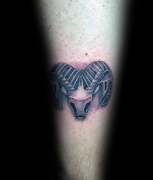 Black and grey Dodge Ram tattoo on forearm, featuring bold shading and red eyes for a fierce, masculine look.