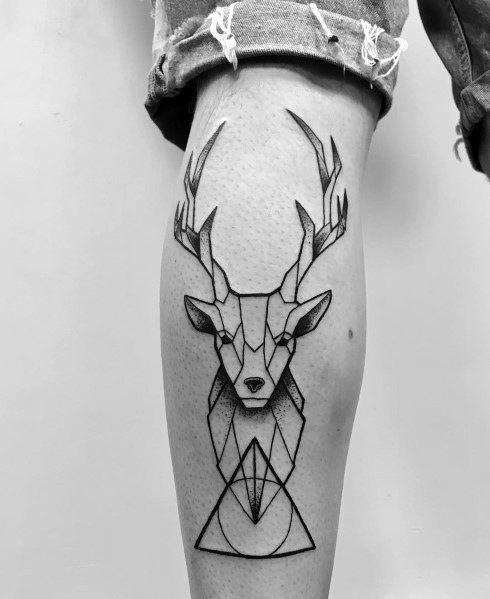 Minimalist geometric elk tattoo on a man's calf, featuring clean black lines and sharp angles for a modern and artistic design.
