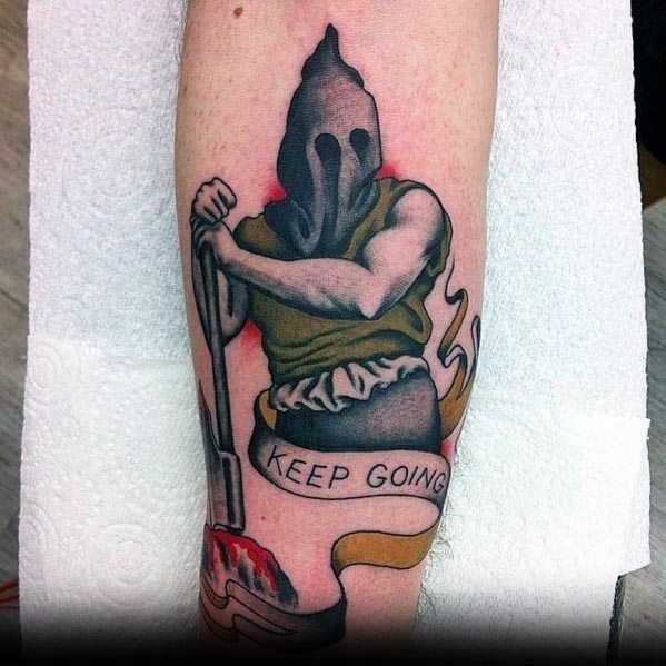 Executioner tattoo featuring a hooded figure with a muscular arm holding an axe, a banner reading 'Keep Going,' and a bloodied guillotine.